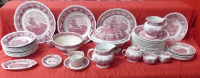 many plates and cups on a red table cloth