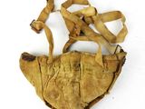 an old, worn, leather purse with a strap on it