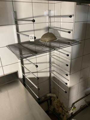 an image of a kitchen with a pizza on a shelf