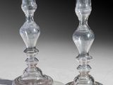 two clear glass candlesticks sitting on a table