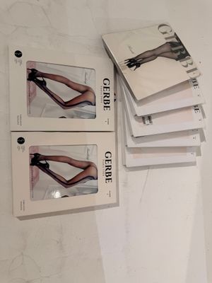 four books on a table with a pair of heels on top of them