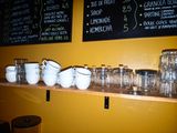 many glasses and cups on a shelf in a room