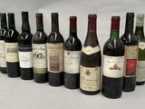 several bottles of wine are lined up in a row on a table