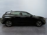 the black car is parked on the concrete floor in the room