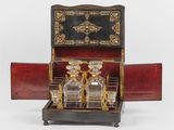 a small wooden box with a glass decanter in it