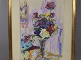 tableau représentant un vase de fleurs dans un cadre doré posé sur une table