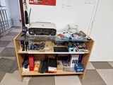 a desk with a printer and other electronics on it