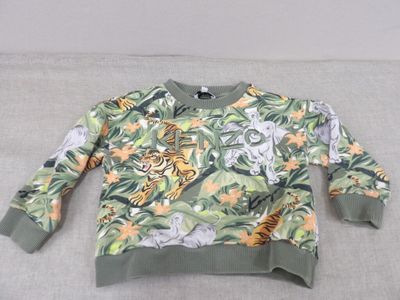 the sweater is green and has a tiger and tiger print on it