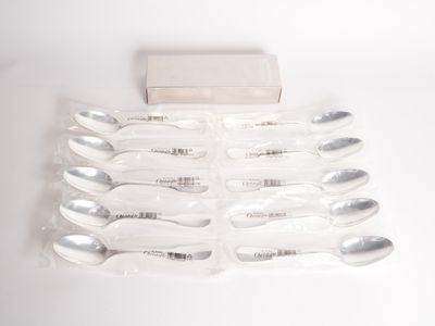 six spoons and a box on a white surface