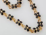an image of a black and gold necklace and bracelet set