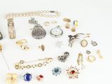 an assortment of jewelry including a watch, bracelet, broocher, and other items