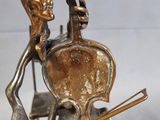 a statue of a man and a woman playing a violin