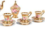 five cups and a teapot on a saucer and saucer