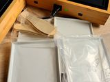 a wooden box with a phone inside of it on a table