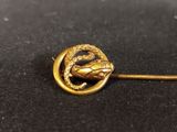 an image of a gold broochle with a snake on it