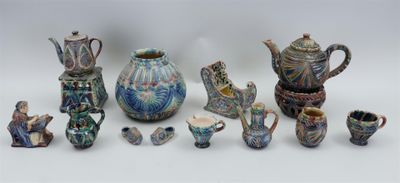 many pieces of pottery that are sitting on a table