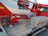 a red crane that is sitting on the back of a truck