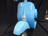 a blue scooter that is sitting on a black background