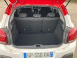 the back of a car with the trunk open and the back seats folded down