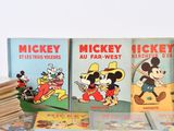mickey mouse books are stacked on top of each other on a table