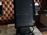 a computer monitor sitting on top of a wooden table