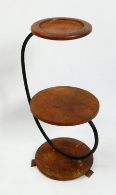 a three tiered wooden table with two plates on it