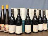 several bottles of wine are lined up on a table