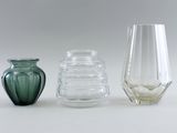 three glass vases sitting next to each other on a table