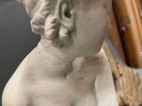 a statue of a woman with a flower in her hair