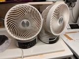 two white fans sitting on top of a kitchen counter