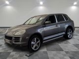 a picture of a silver porsche cayen parked in a garage