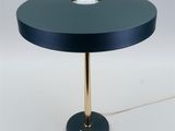 a black table lamp with a white light on top of it