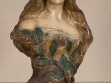 statue d'une femme aux cheveux longs posée sur une table en verre