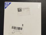 an envelope with a barcode on it sitting on top of a table