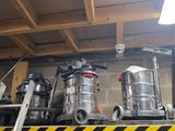 de nombreux modèles d'aspirateurs sur une étagère dans un garage