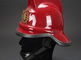 a red fireman ' s helmet on a black mannequin head