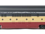 two toy trains sitting side by side on a white surface