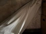 un drap blanc accroché au mur à côté d'une commode