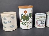 three different types of kitchen canisters are lined up on a table