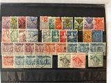 an old collection of postage stamps on display in a black case