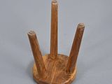 a wooden holder with three wooden sticks on it