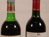 two bottles of wine sitting next to each other on a table