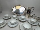 a lot of dishes and cups sitting on a table