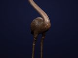 a bronze statue of a bird on a blue background