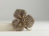 a close up of a ring with a flower on it