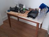 a wooden table with a laptop on it in a room