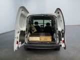 a white van with its doors open in a room