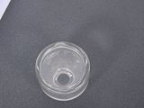 a glass of water sitting on top of a black table