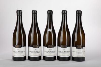four bottles of wine are lined up on a table