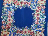 a blue scarf with a floral design on it